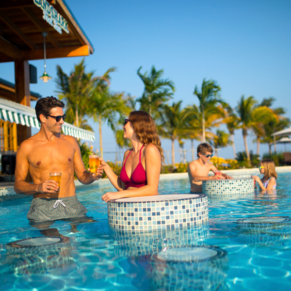Family at pool enjoying drinks