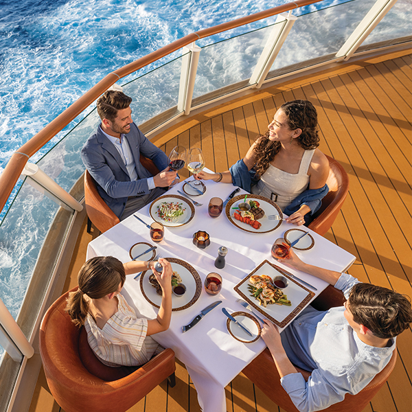 Family enjoying dinner on deck